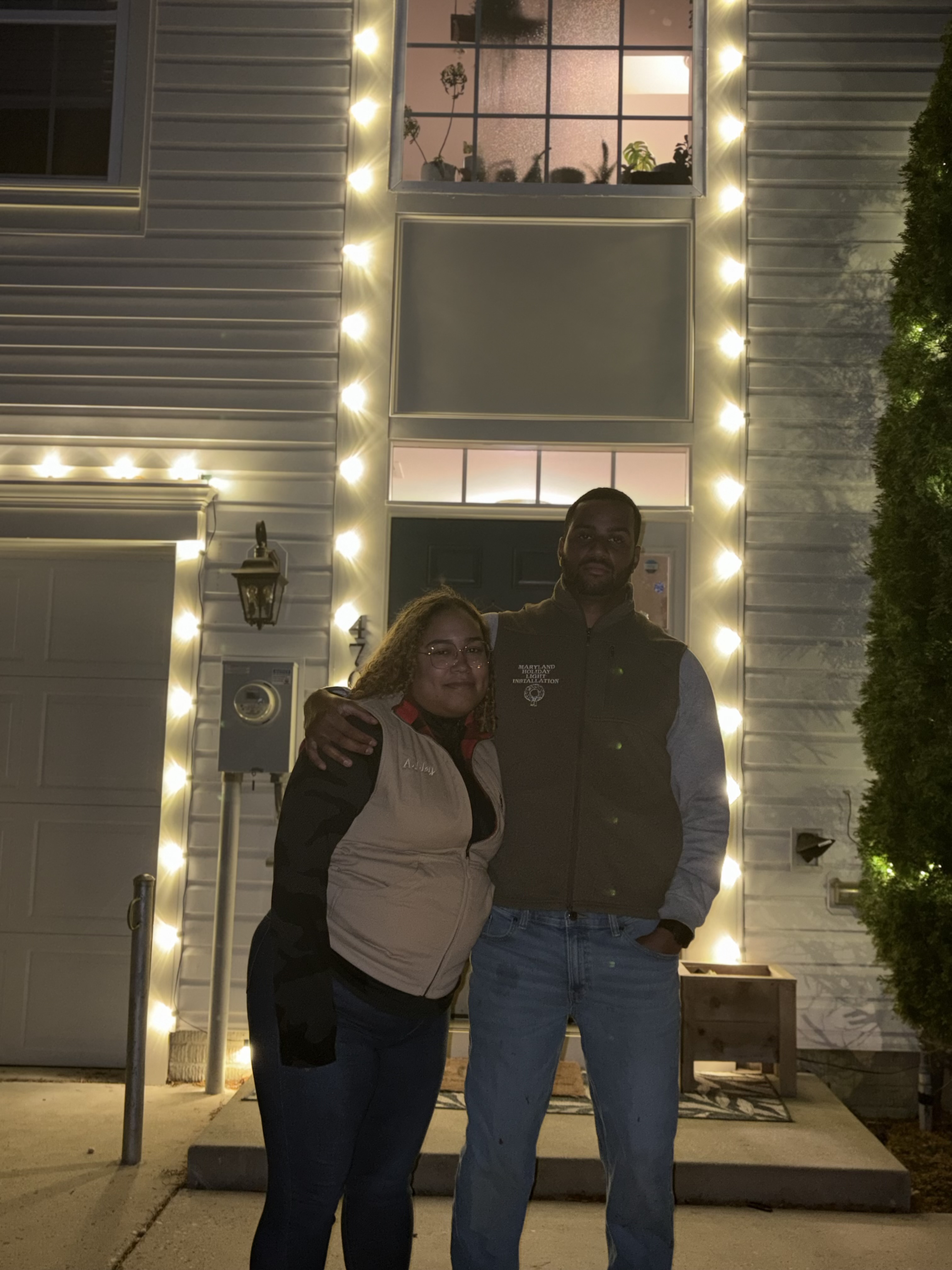 The owner and family behind Holiday Lights DMV after a completed holiday lighting installation